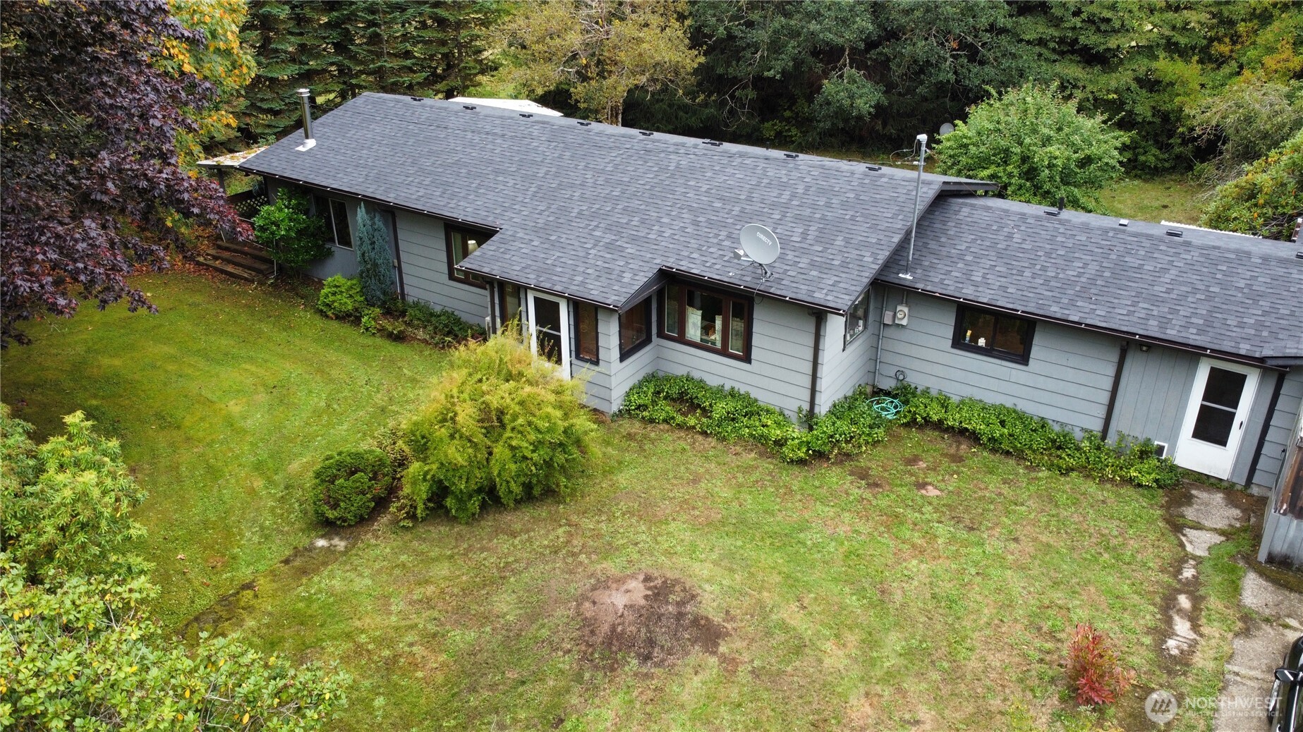 a aerial view of a house with yard and green space