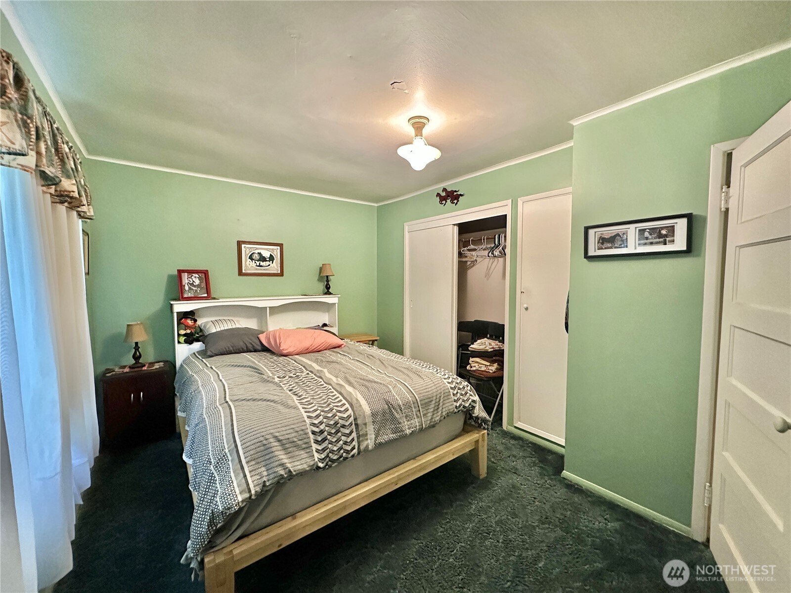 945 Highway 101 Cosmopolis, WA 98537 - Photo 15 of 39 a bedroom with a bed and a walk in closet