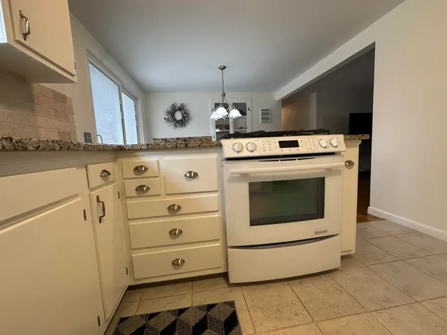 a stove top oven sitting inside of a kitchen