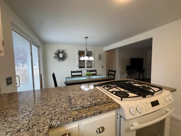 a kitchen with granite countertop a stove and a sink