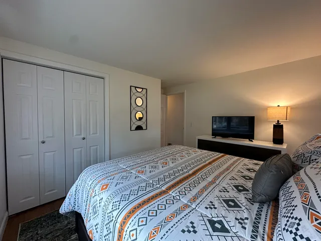 a bedroom with a bed and a television