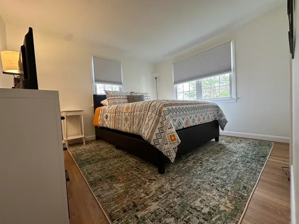 a bed sitting in a bedroom next to a window
