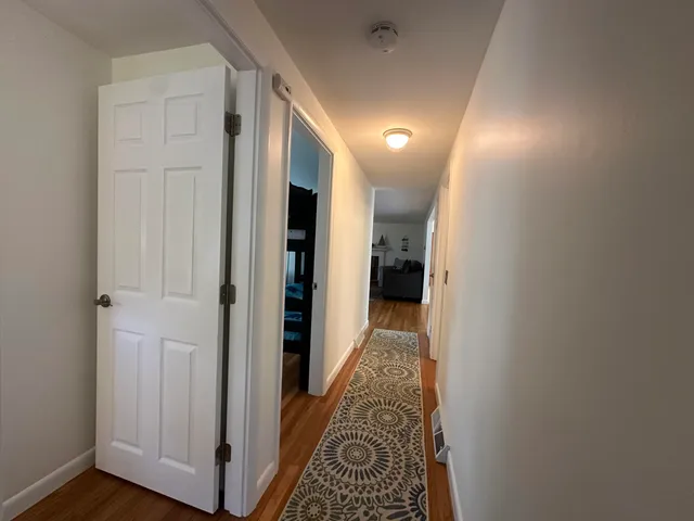 a view of hallway with wooden floor