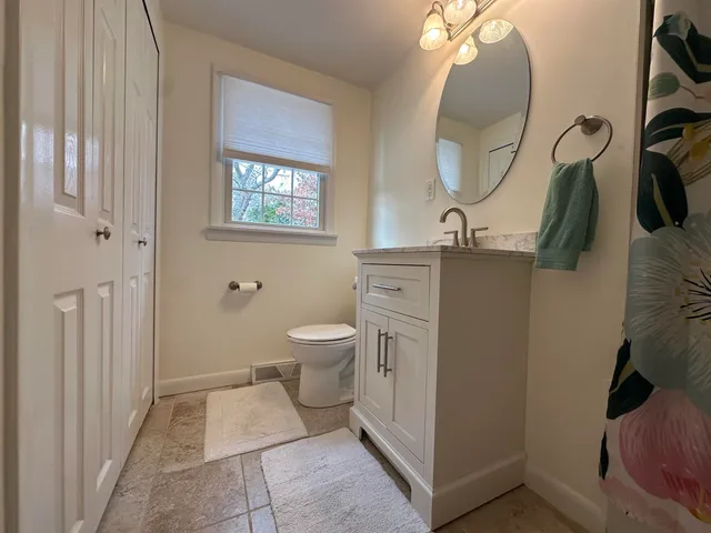 a bathroom with a sink a mirror and a toilet