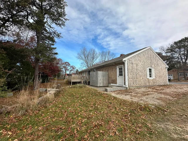 a view of a backyard with large trees