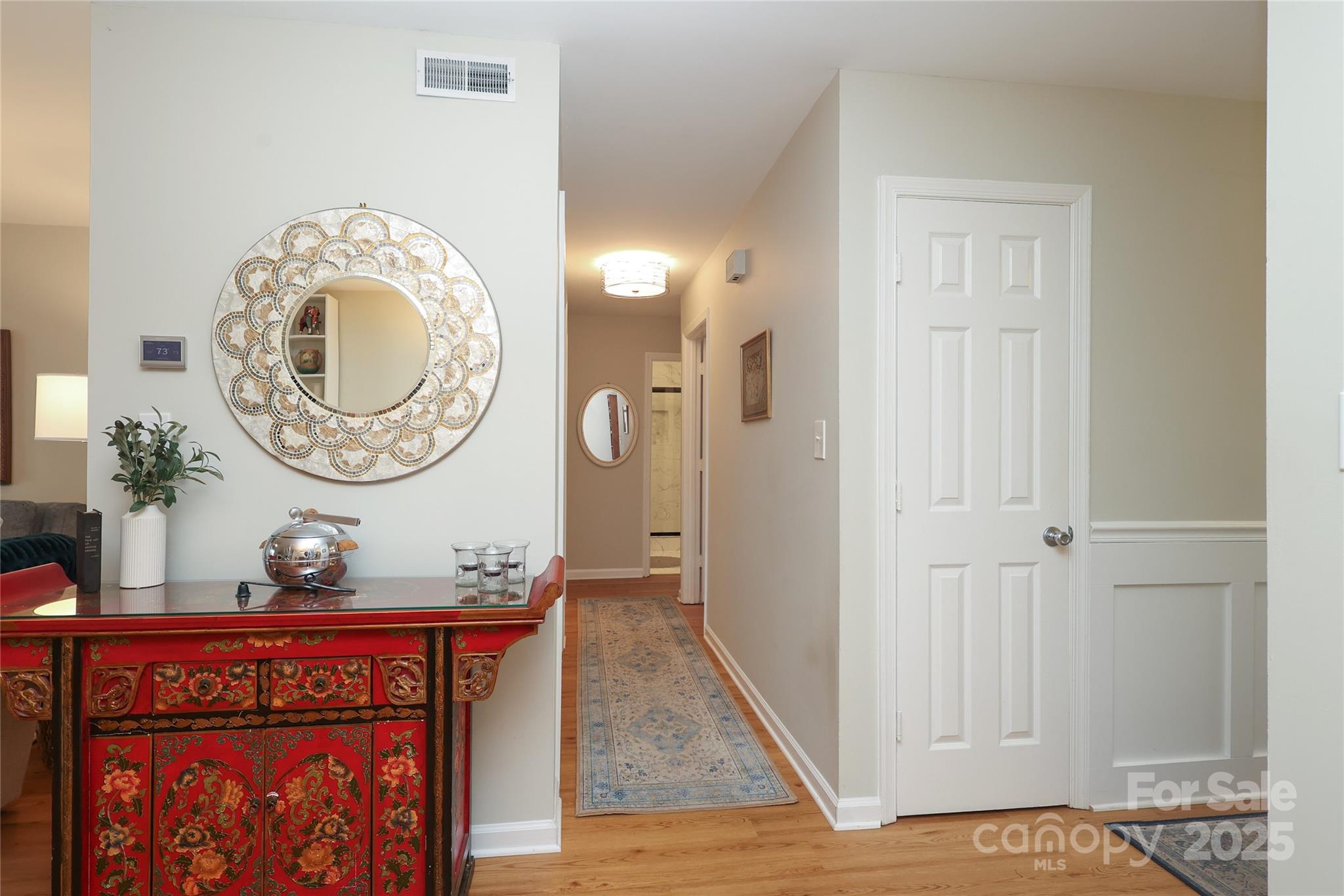 8084 Knights Bridge Road Charlotte, NC 28210 - Photo 13 of 30 a view of a hallway with entryway wooden floor and front door