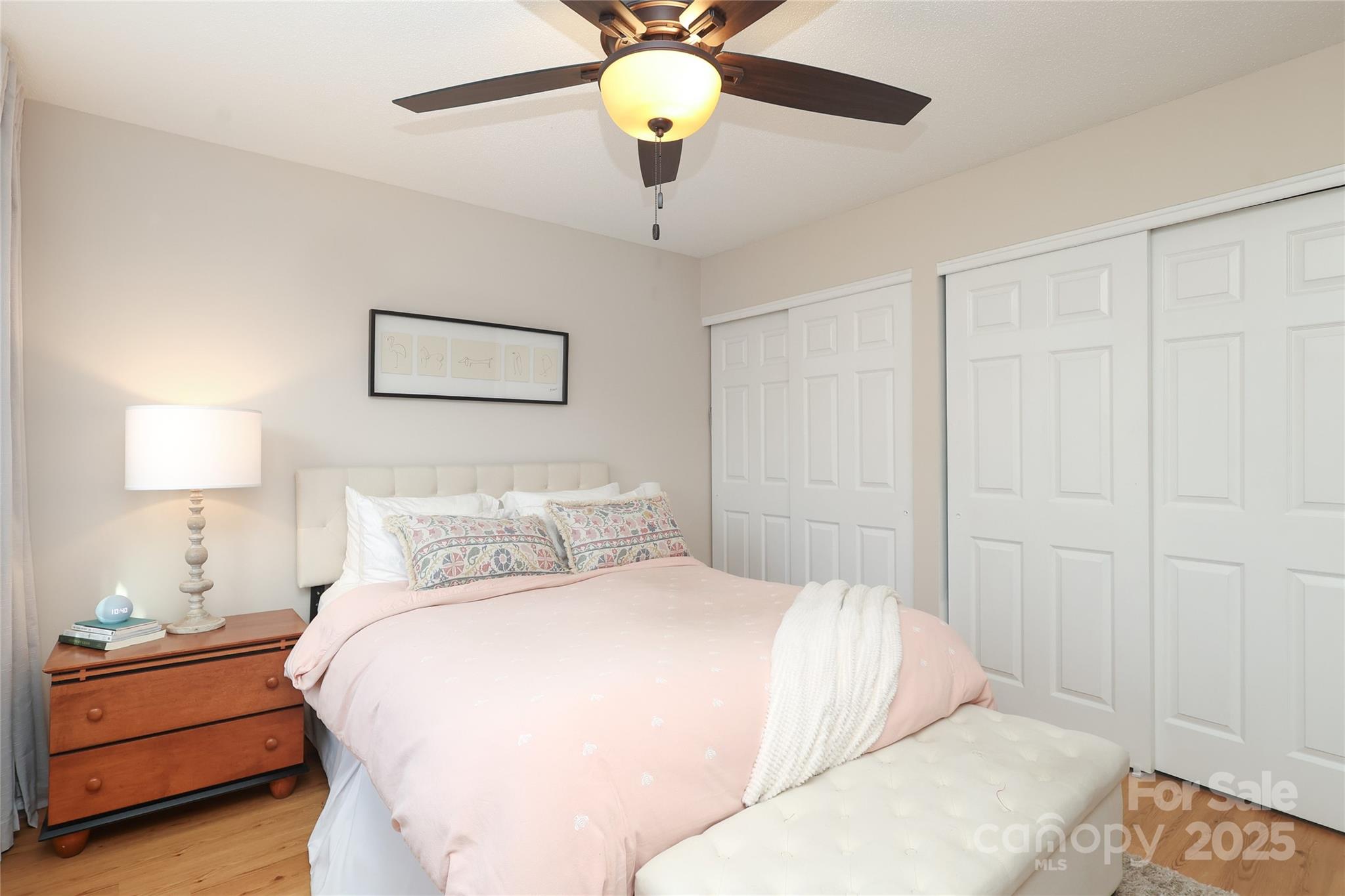 8084 Knights Bridge Road Charlotte, NC 28210 - Photo 15 of 30 a bedroom with a bed and a chandelier