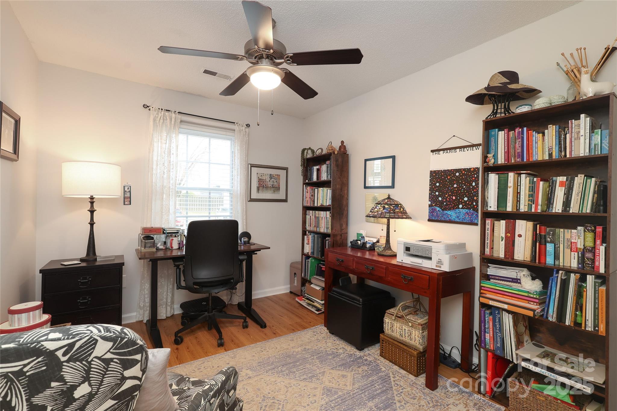 8084 Knights Bridge Road Charlotte, NC 28210 - Photo 20 of 30 a view of a workspace with furniture and a book shelf