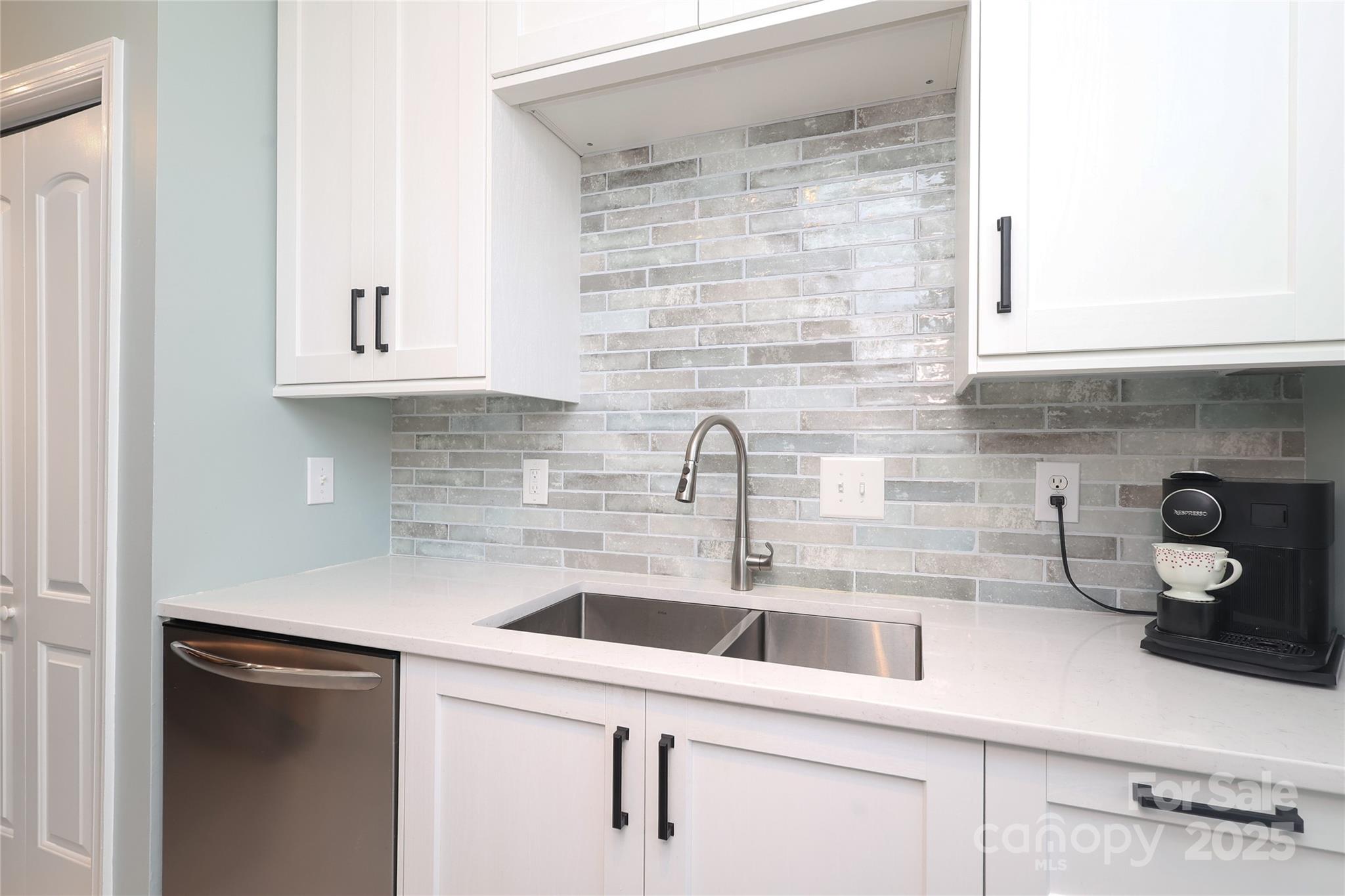 8084 Knights Bridge Road Charlotte, NC 28210 - Photo 9 of 30 a kitchen with a sink cabinets and a window
