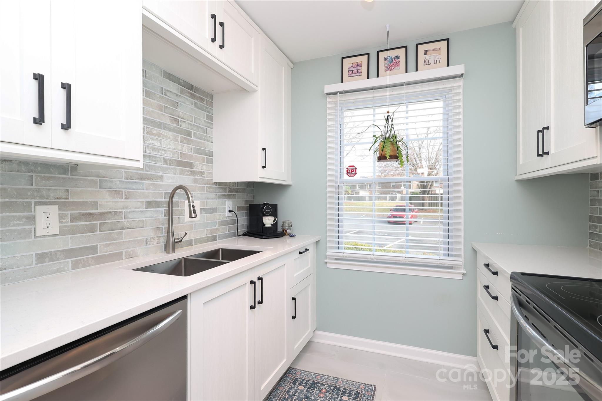 8084 Knights Bridge Road Charlotte, NC 28210 - Photo 10 of 30 a kitchen with a sink cabinets and window