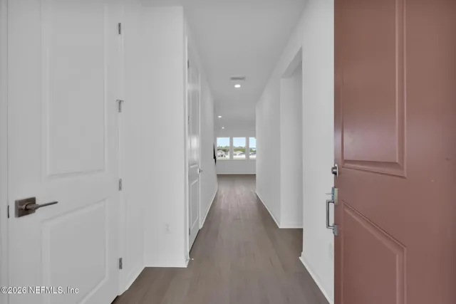 a bathroom with a granite countertop sink a toilet and a mirror