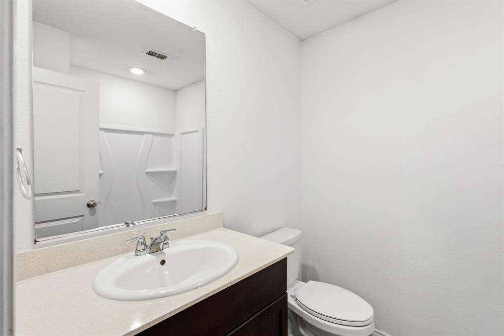 2604 Spring Time Drive Ennis, TX 75119 - Photo 4 of 21 a bathroom with a sink toilet and mirror