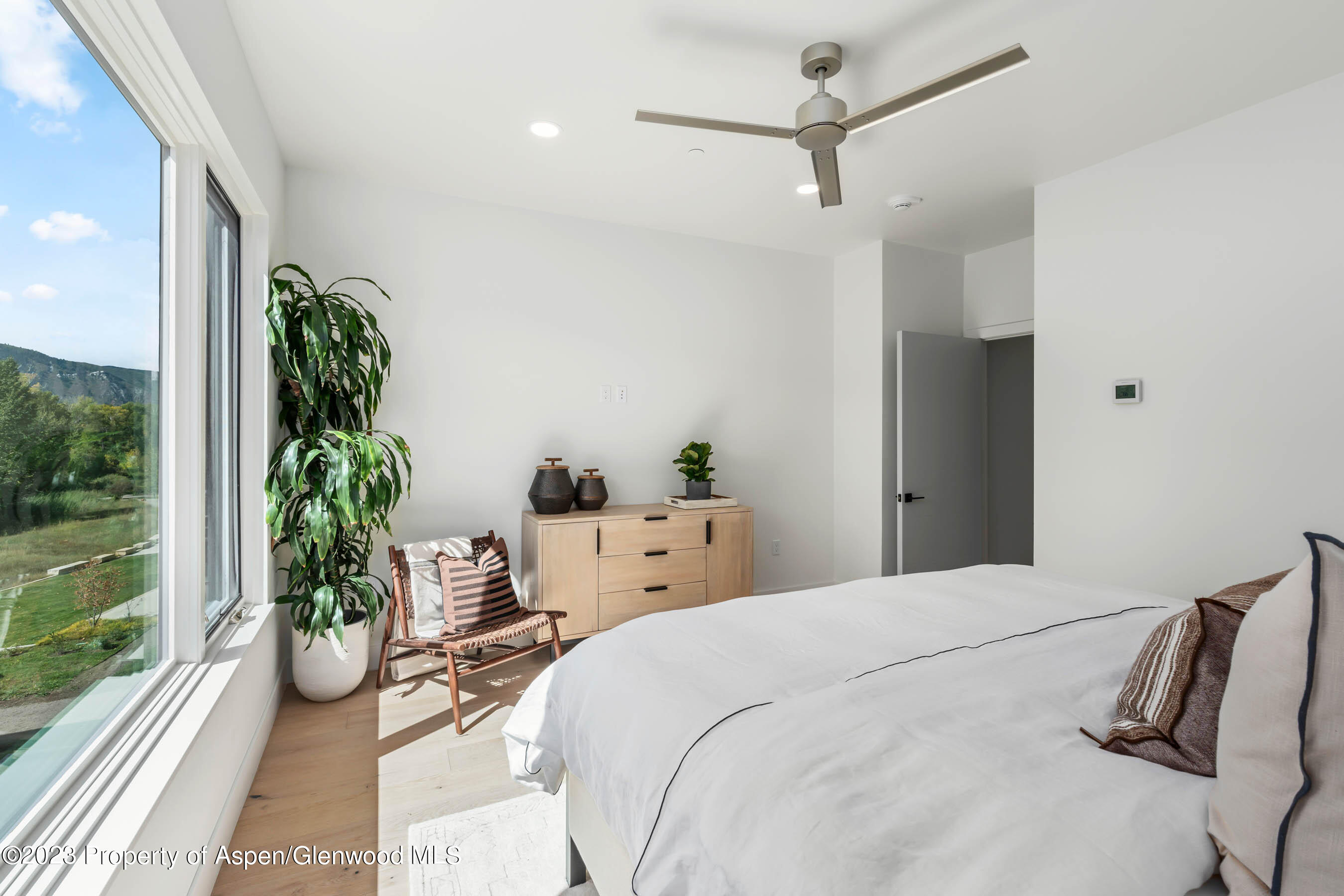22840 Two Rivers Road, Unit 300 Basalt, CO 81621 - Photo 16 of 28 a bedroom with a bed and a potted plant