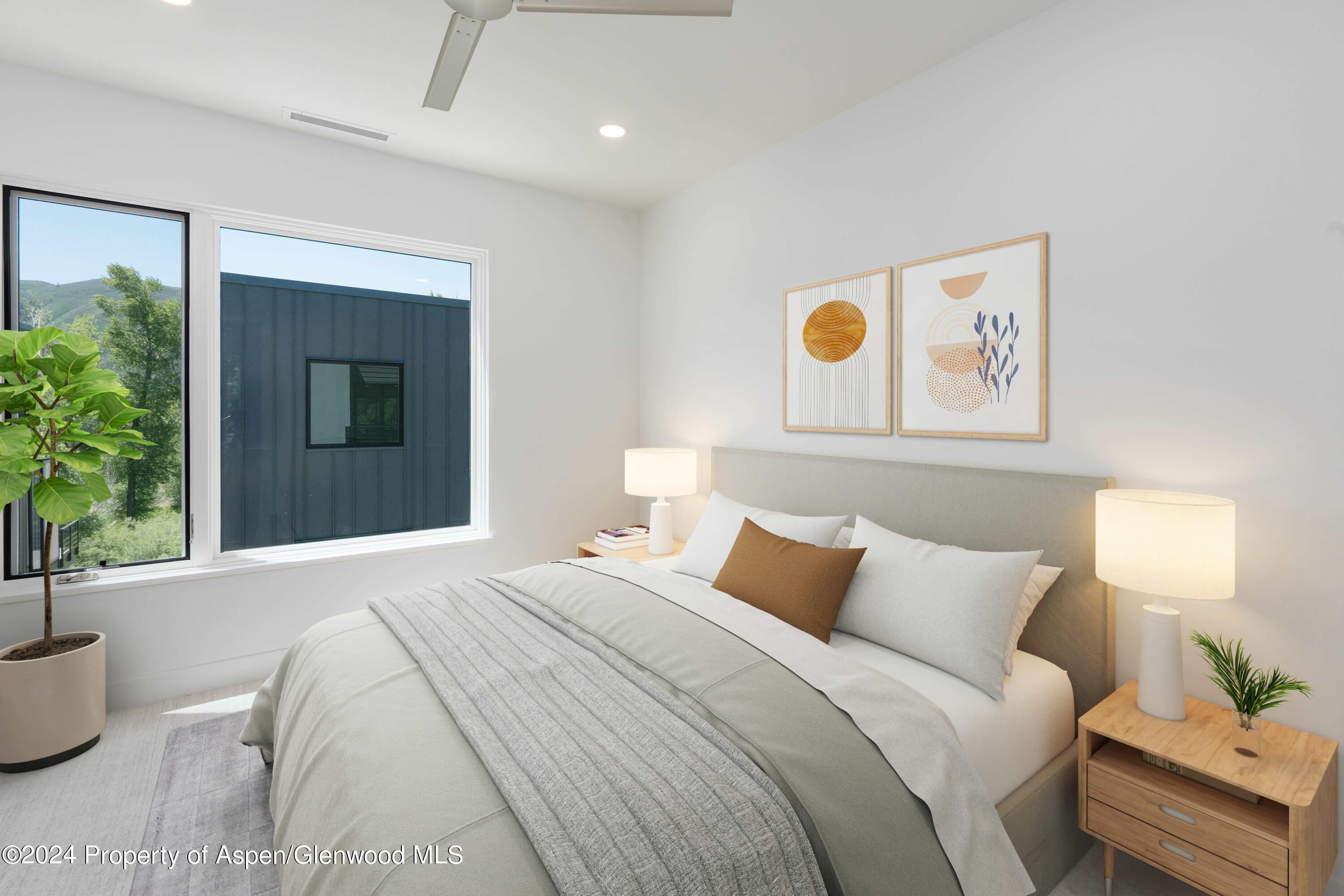 22840 Two Rivers Road, Unit 300 Basalt, CO 81621 - Photo 21 of 28 a bedroom with a bed and a potted plant