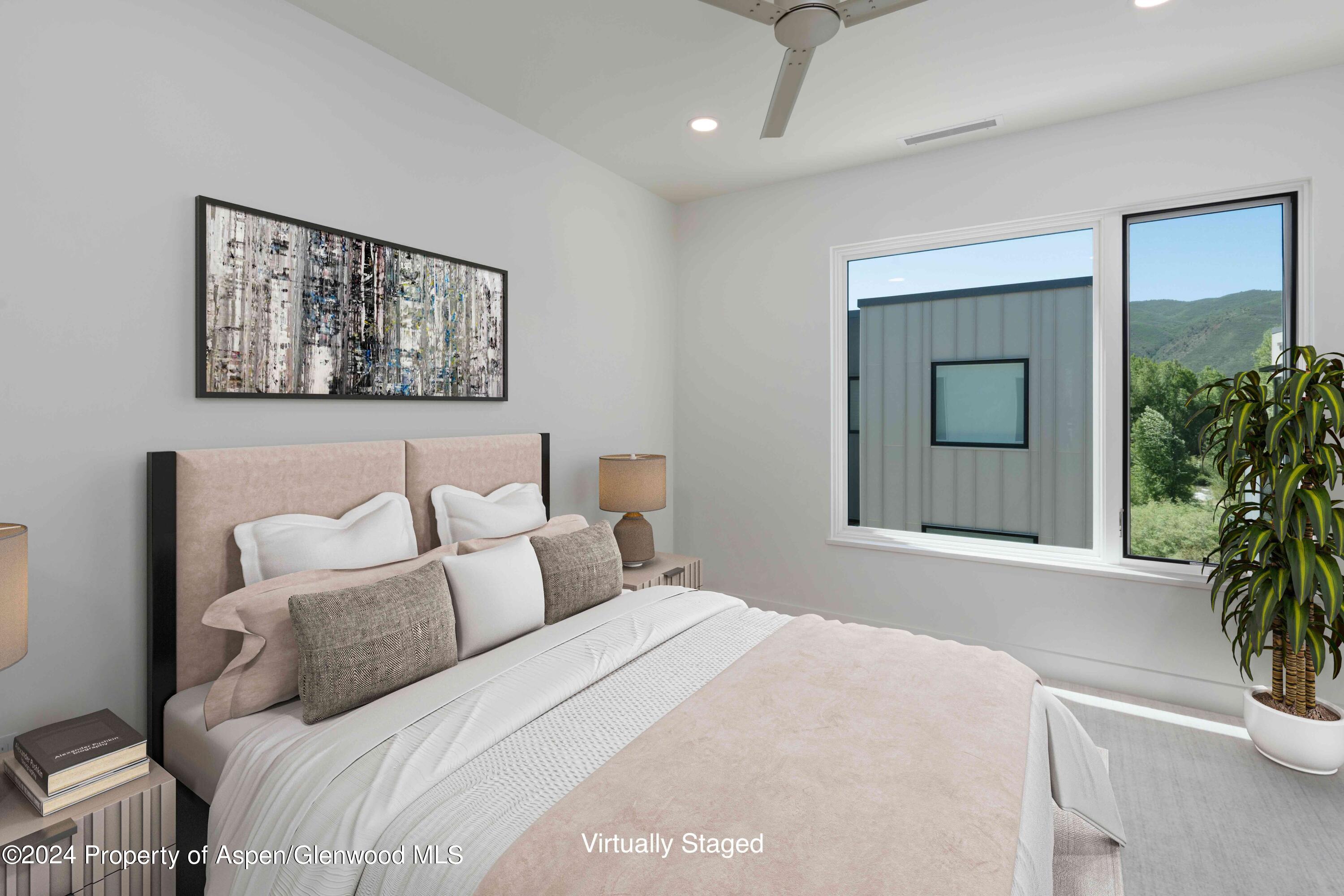22840 Two Rivers Road, Unit 300 Basalt, CO 81621 - Photo 23 of 28 a bedroom with a bed and a potted plant