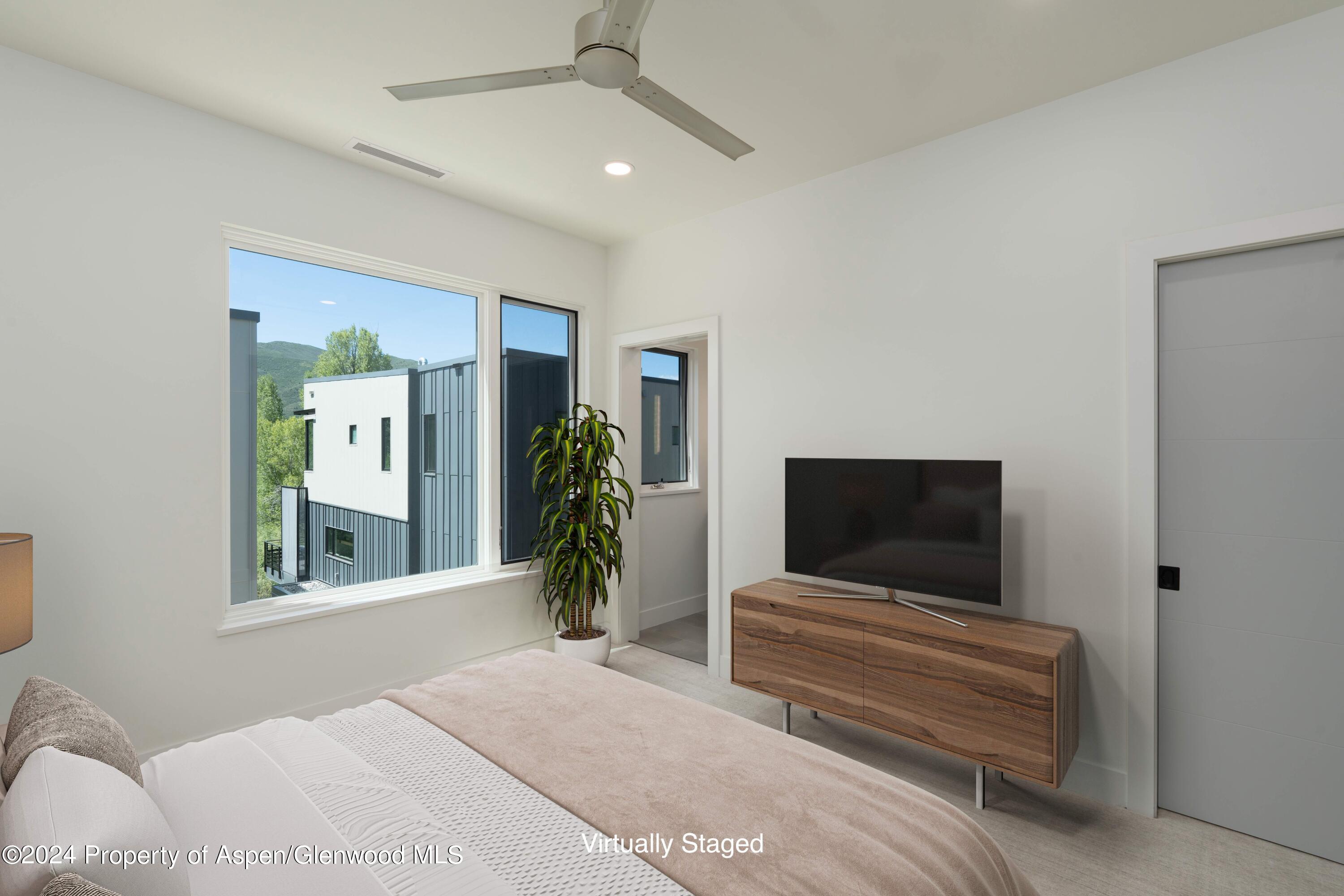 22840 Two Rivers Road, Unit 300 Basalt, CO 81621 - Photo 24 of 28 a bedroom with furniture and a flat screen tv