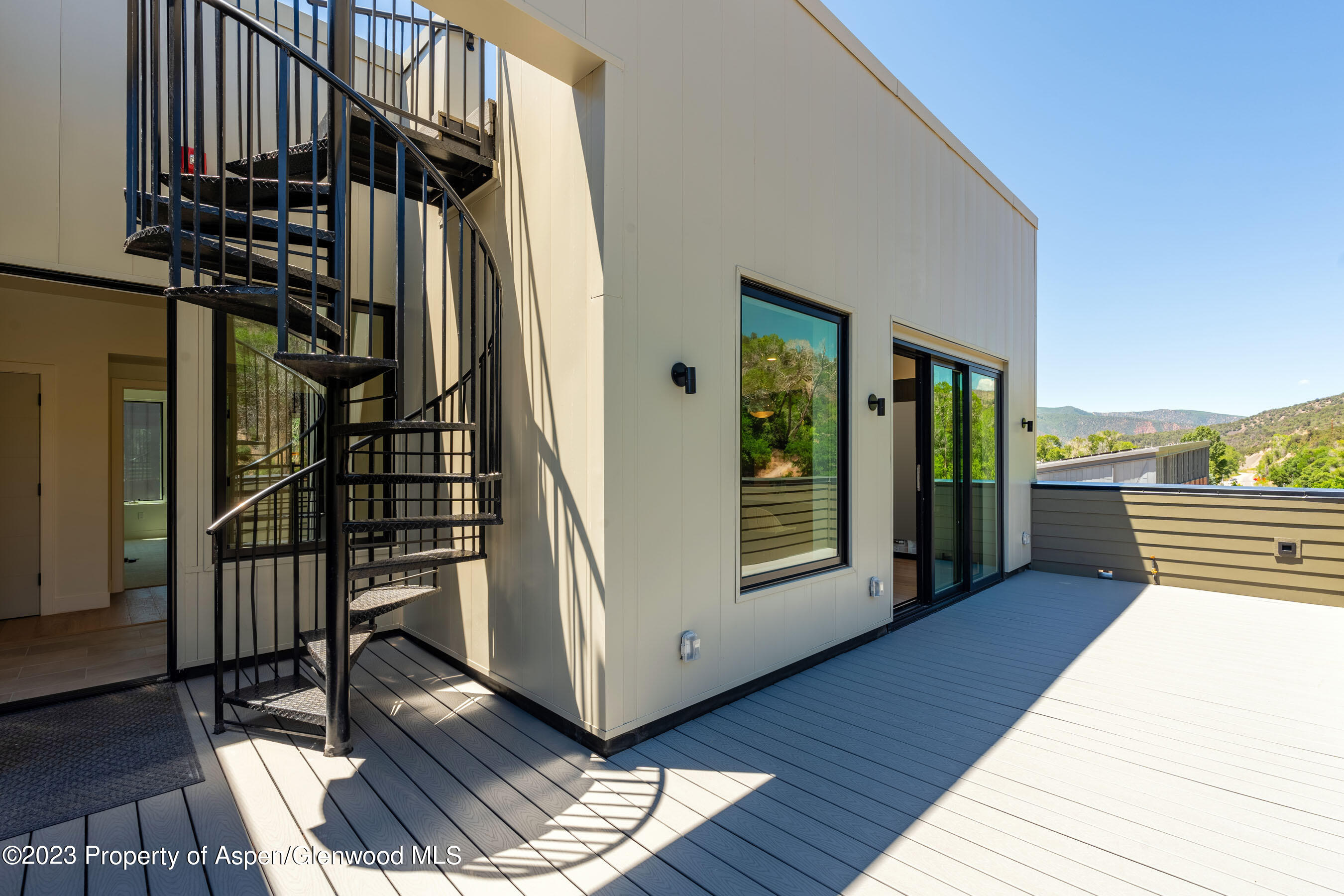 22840 Two Rivers Road, Unit 300 Basalt, CO 81621 - Photo 28 of 28 a view of a balcony with furniture and floor to ceiling window