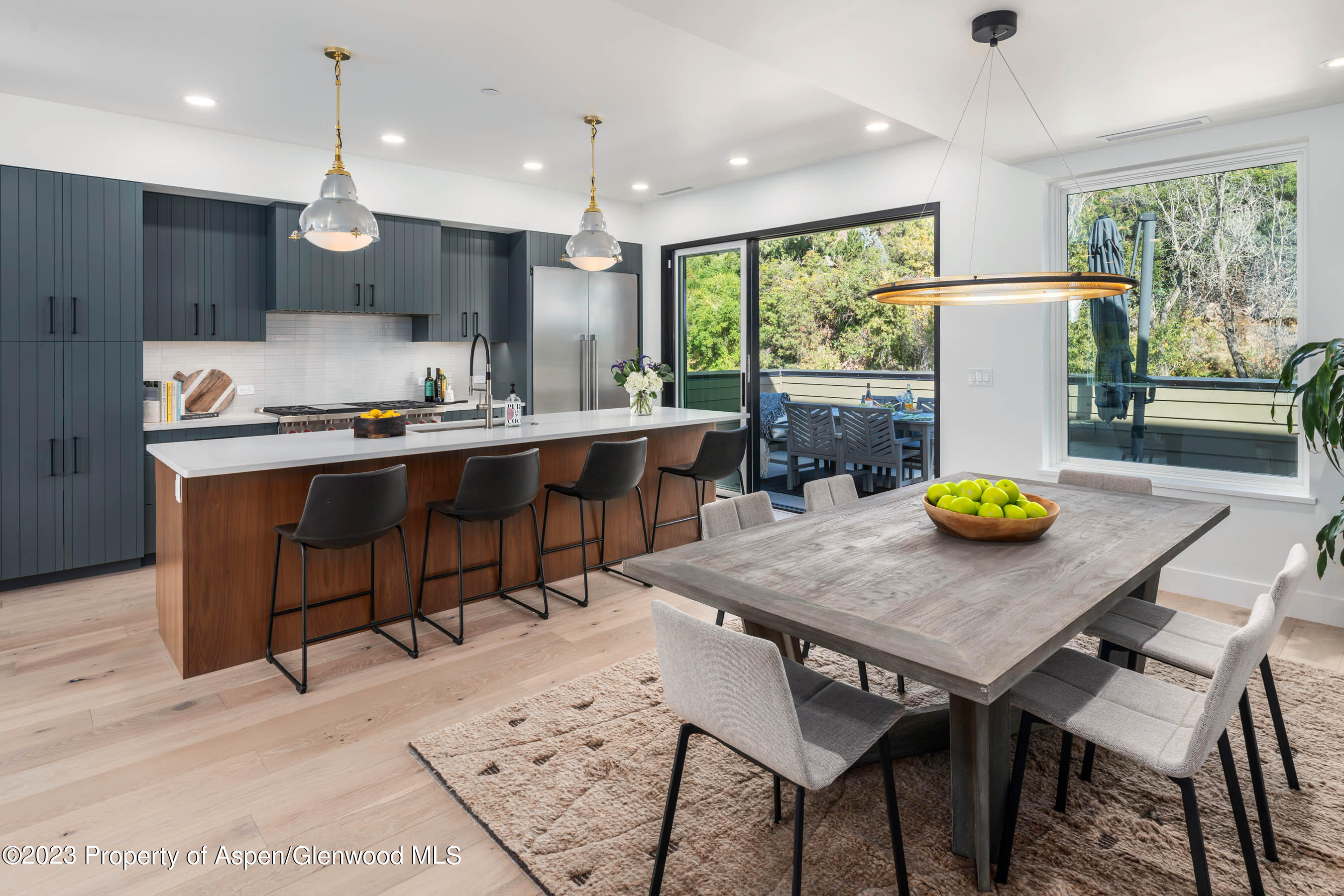 22840 Two Rivers Road, Unit 300 Basalt, CO 81621 - Photo 9 of 28 a kitchen with a table chairs and a view of living room