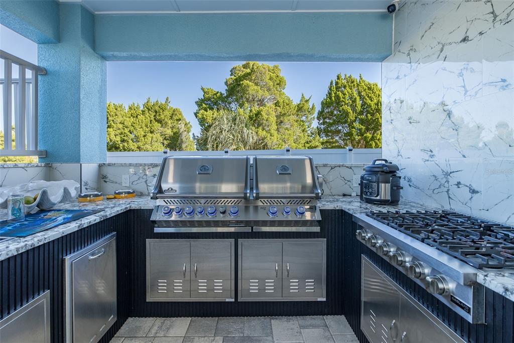 3271 Hibiscus Drive Hernando Beach, FL 34607 - Photo 17 of 95 a kitchen with stainless steel appliances granite countertop a stove a sink and a microwave