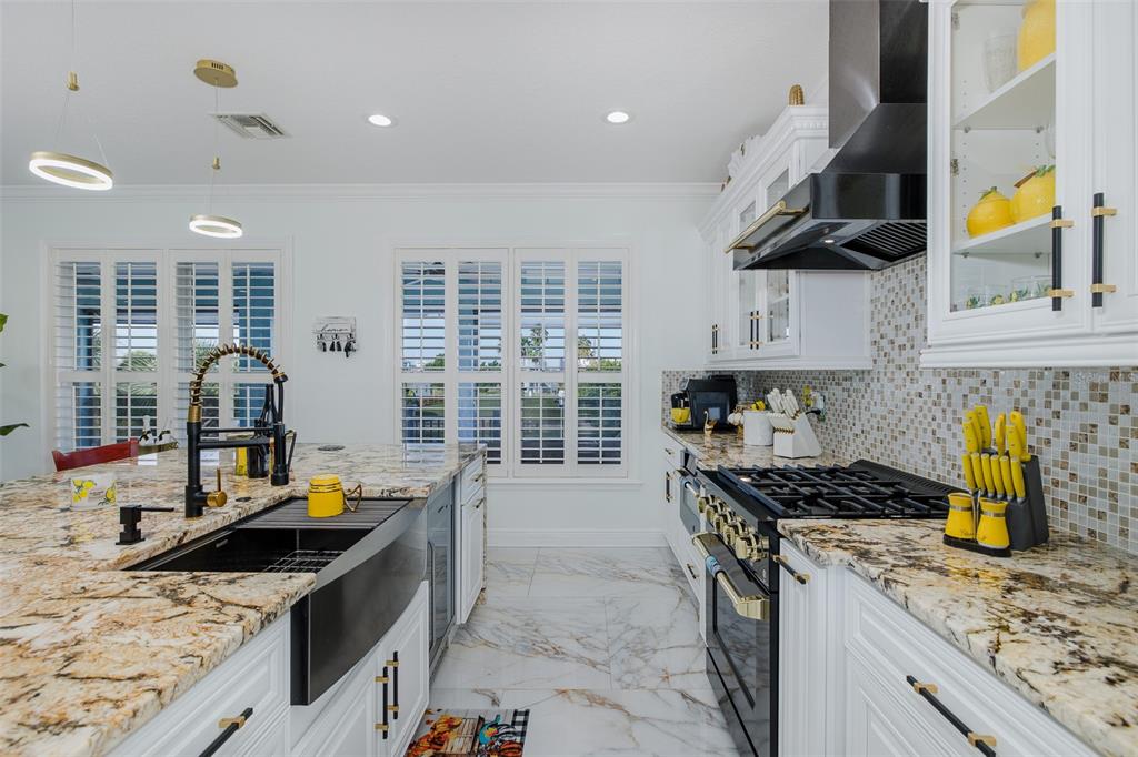 3271 Hibiscus Drive Hernando Beach, FL 34607 - Photo 39 of 95 a kitchen with a stove a sink and a stove