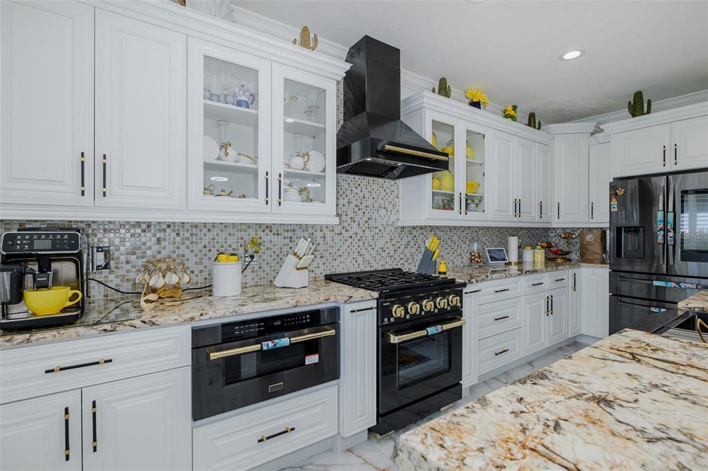 3271 Hibiscus Drive Hernando Beach, FL 34607 - Photo 42 of 95 a kitchen with stainless steel appliances granite countertop a stove a sink dishwasher and a refrigerator