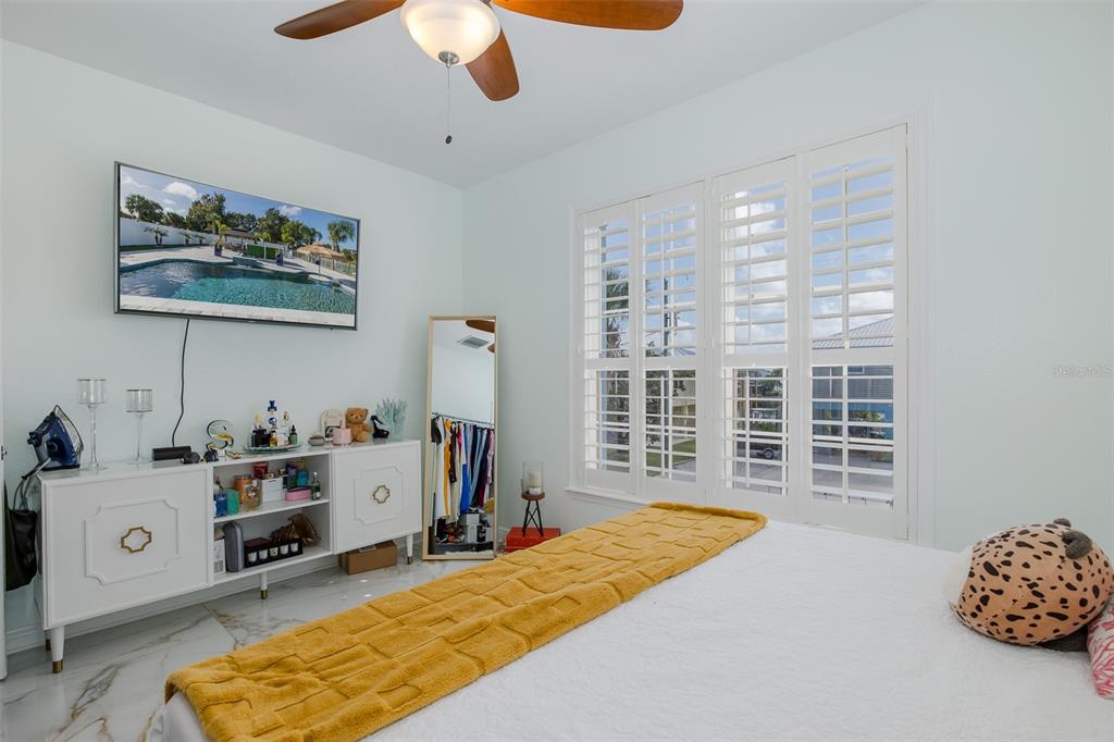 3271 Hibiscus Drive Hernando Beach, FL 34607 - Photo 63 of 95 a bedroom with a bed and a large window