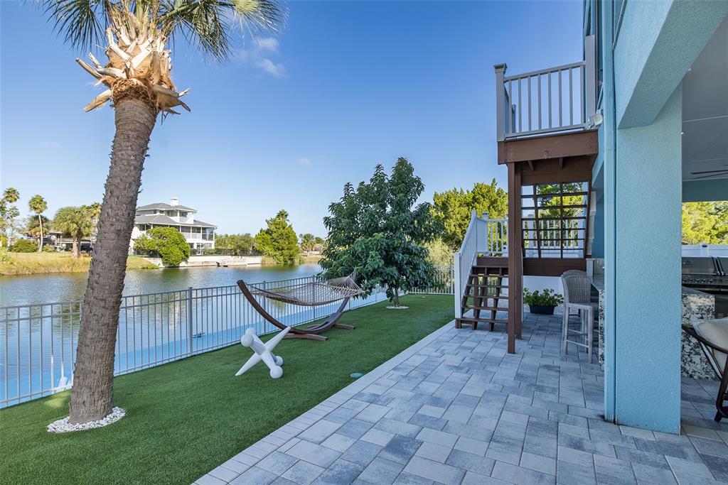 3271 Hibiscus Drive Hernando Beach, FL 34607 - Photo 83 of 95 a view of a chair and table in backyard of the house