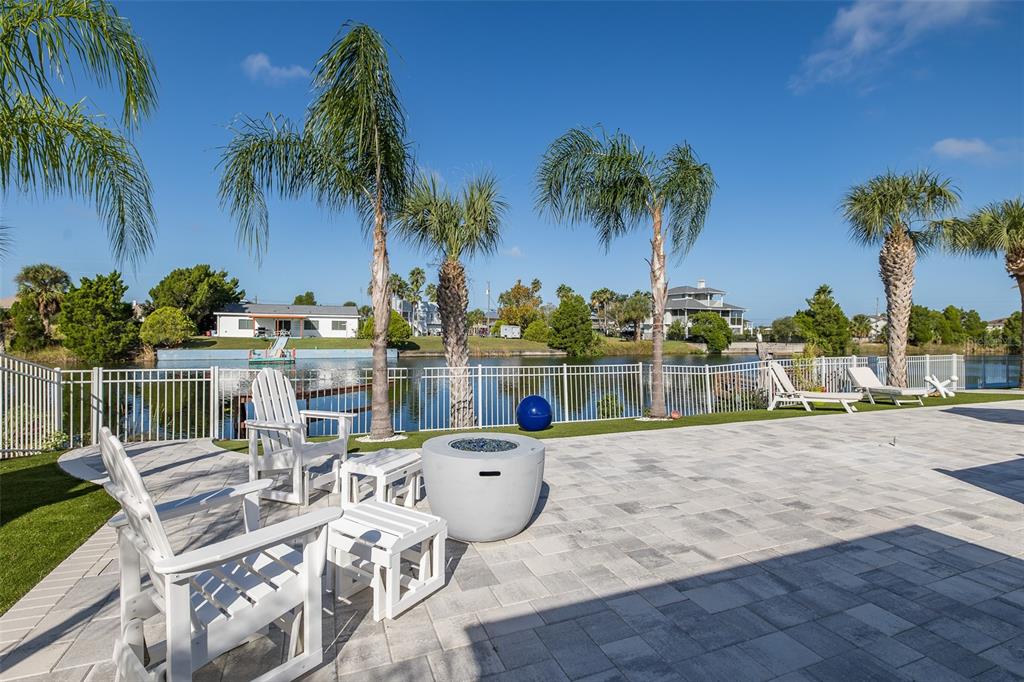 3271 Hibiscus Drive Hernando Beach, FL 34607 - Photo 84 of 95 a view of a swimming pool with a table and chairs