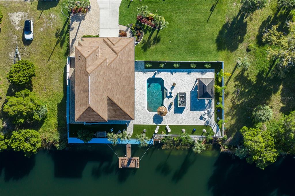 3271 Hibiscus Drive Hernando Beach, FL 34607 - Photo 9 of 95 an aerial view of a house with pool yard outdoor seating and yard