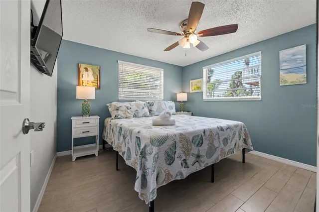 a spacious bedroom with a bed and a chandelier