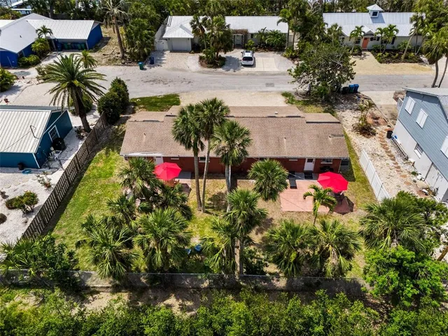 an aerial view of multiple houses with yard