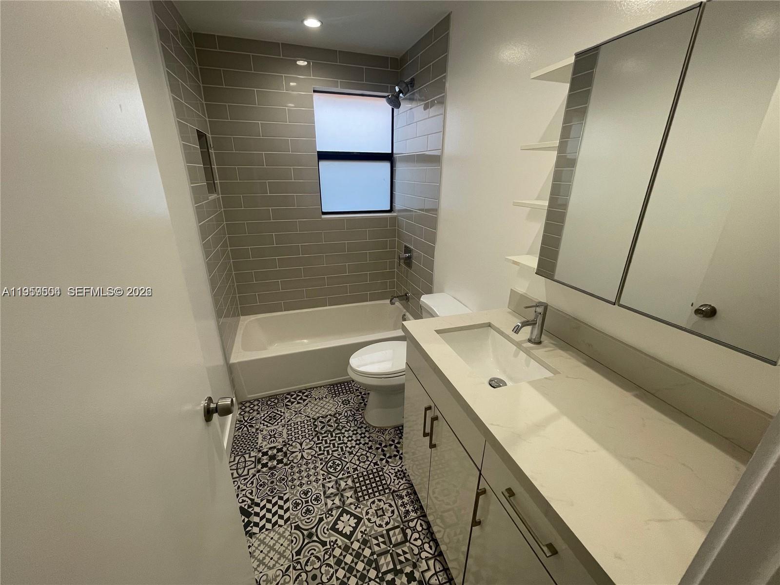 1637 Southwest 10th Street, Unit 2 Miami, FL 33135 - Photo 8 of 9 a bathroom with a sink a toilet and shower