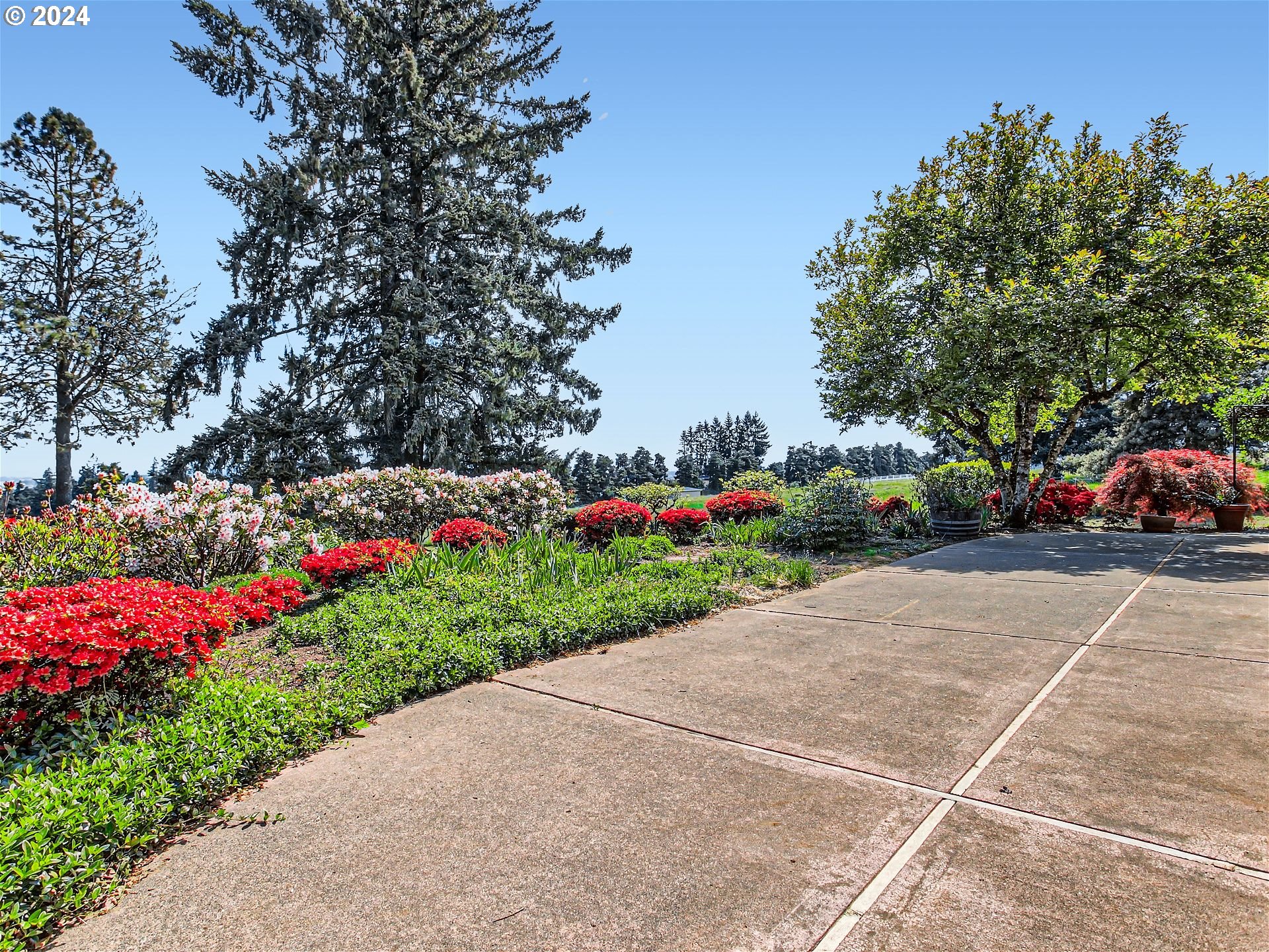 27151 Southwest Baker Road Sherwood, OR 97140 - Photo 26 of 37 a green field with flowers and trees