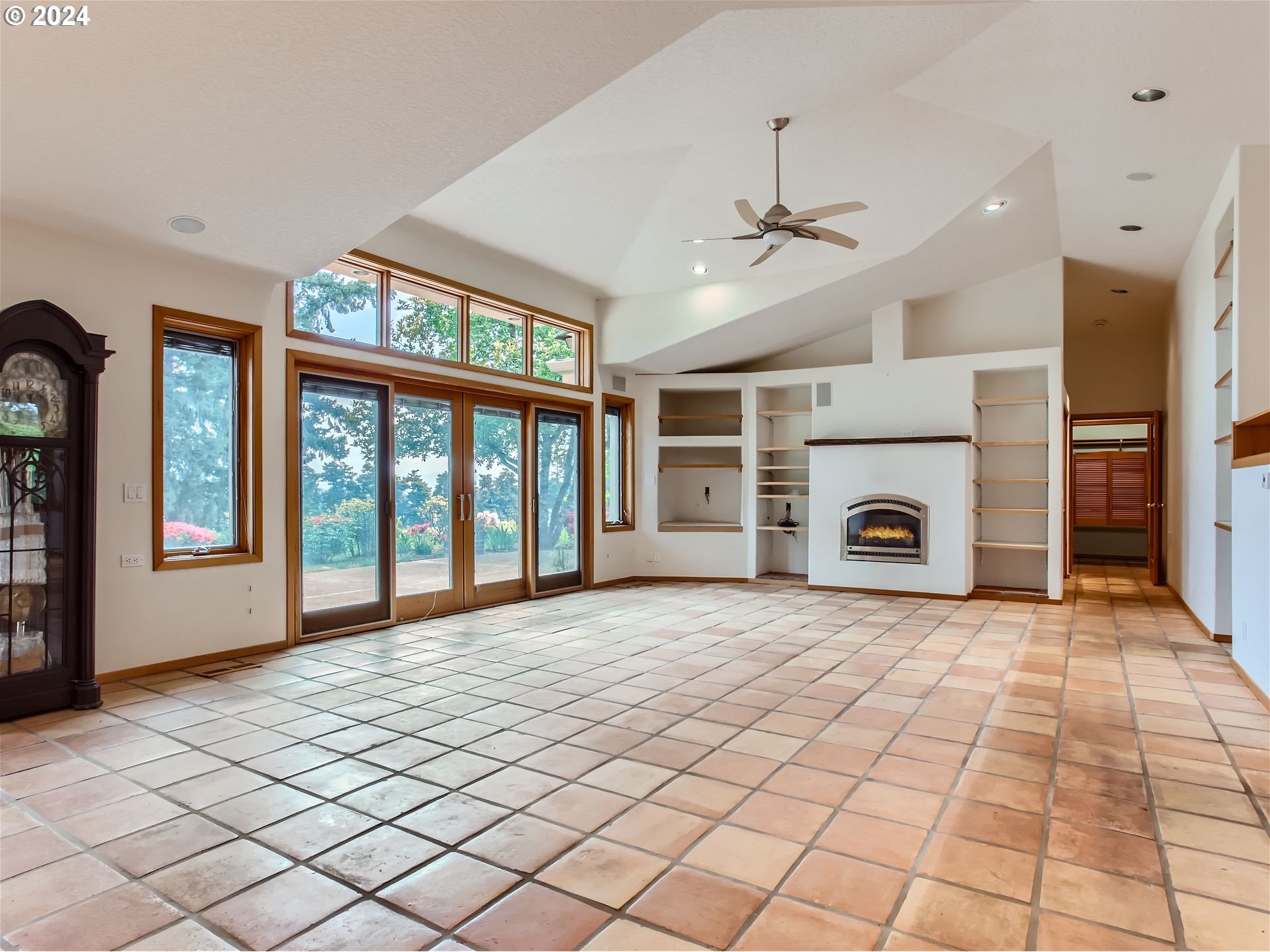 27151 Southwest Baker Road Sherwood, OR 97140 - Photo 7 of 37 a view of a livingroom with a fireplace a ceiling fan and windows