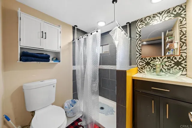 a bathroom with a sink toilet and shower