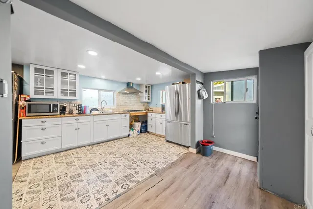 a kitchen with sink refrigerator and cabinets
