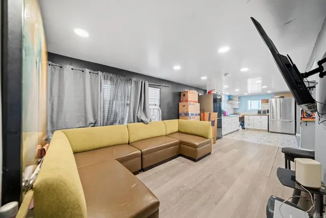 a living room with couches and a flat screen tv