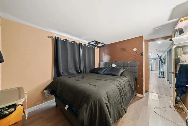 a bed sitting in a bedroom next to a window