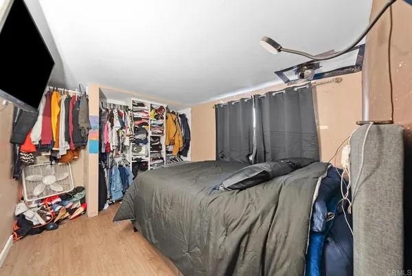 a view of walk in closet with clothes