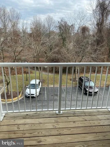 a view of a balcony with two chairs and a table