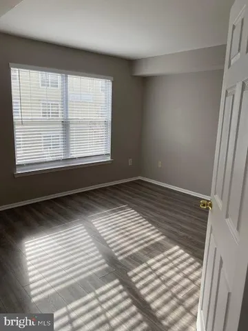 a view of wooden floor and windows in a room