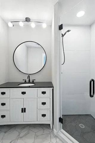 a bathroom with a sink a mirror and shower
