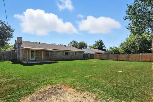 a view of a big yard with a house