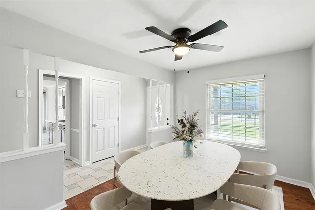 a view of a livingroom with a dining table & a window