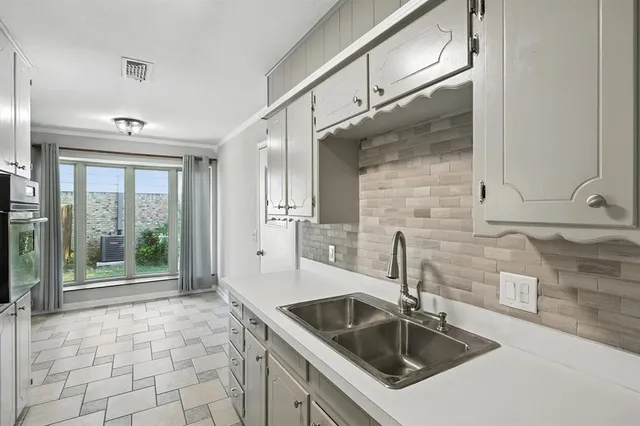 a kitchen with granite countertop a sink and a refrigerator