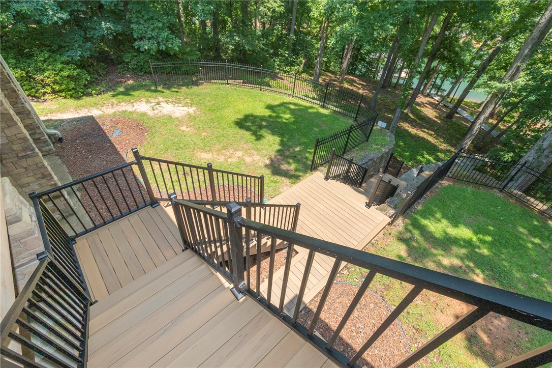 202 Plantation Point Anderson, SC 29625 - Photo 31 of 48 Descend from the deck to a manicured lawn, leading to a private waterfront view.