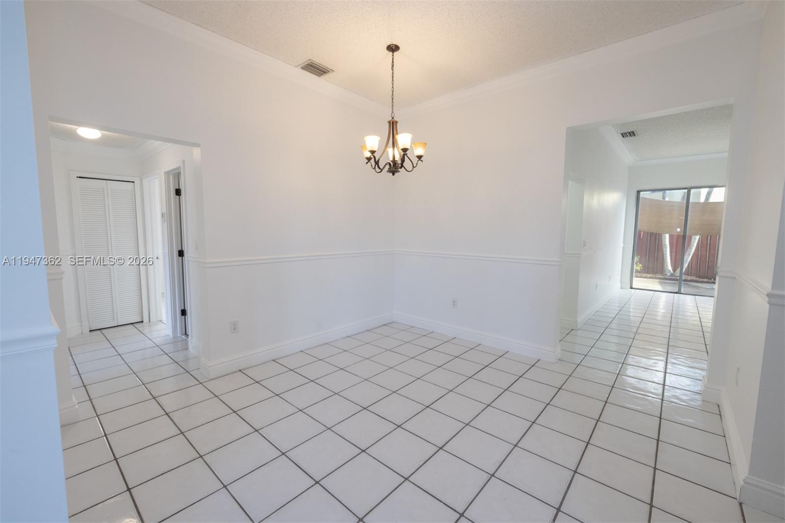 16244 Southwest 81st Street Miami, FL 33193 - Photo 15 of 35 a view of a hallway with chandelier