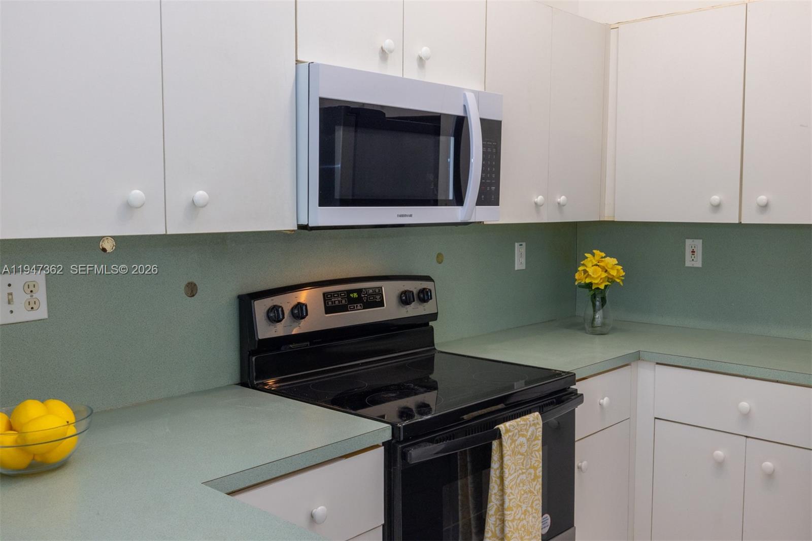 16244 Southwest 81st Street Miami, FL 33193 - Photo 17 of 35 a kitchen with a stove and a microwave