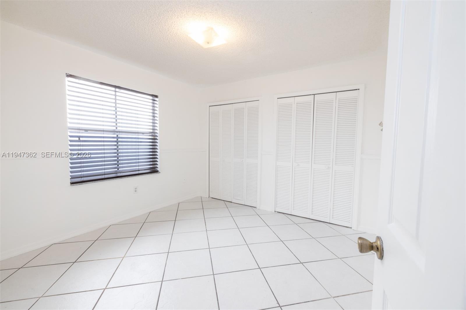 16244 Southwest 81st Street Miami, FL 33193 - Photo 27 of 35 a view of an empty room with a window