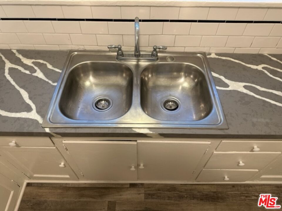 a close view of sink with granite countertop